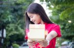 Portrait Of Thai Teen Beautiful Girl In Chinese Dress, Happy New Year And Open Box Gift, Smile And Very Happy Stock Photo