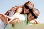 Young Couple Piggy Backing Stock Photo