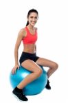 Woman In Gym Exercising With Pilates Ball Stock Photo