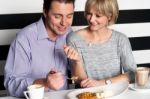 Couple Rejoicing Their Meal In Food Court Stock Photo