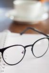 Eyeglasses On Opened Spiral Notebook Stock Photo