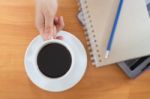 Hot Cup Of Coffee On Working Table Stock Photo