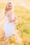 Lonely Beautiful Young Blonde Girl In White Dress With Straw Hat Stock Photo