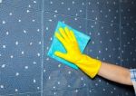 Woman Washes A Tile In The Bathroom Stock Photo