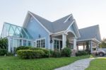 Bright Blue House In Sunlght With Colorful Poppies And Some Grac Stock Photo