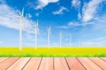 Wind Turbine On Green Rice Field Against Blue Sky Background Stock Photo