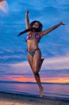 Beautiful Black African American Woman Jumping On The Beach At S Stock Photo