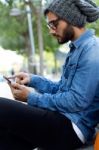 Modern Young Man With Mobile Phone In The Street Stock Photo