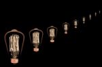 Incandescent Light Bulb On Black Background Stock Photo