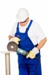 A Worker Grinding A Chunk Of Iron Stock Photo