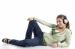 Female Lying And Listening Music Stock Photo