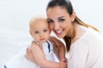 Baby Girl And Her Mother Playing At Home Stock Photo