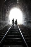 Couple Walking Together Through A Railway Tunnel Stock Photo