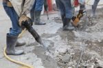 Worker Of Road Construction Drilling Cement Ground Stock Photo