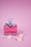 Pink Aromatic Perfume With Pink Pearls With Pink Textile Roses On Pink Background Stock Photo