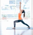 Asian Woman Doing Yoga Indoors Stock Photo