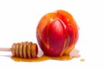 Peach With Honey Dipper Stock Photo