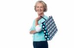 Senior Woman Posing With Shopping Bag Stock Photo