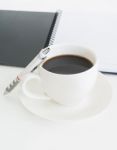 Coffee Cup With Note Book And Pencil Stock Photo