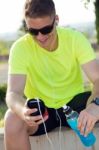 Handsome Young Man Listening To Music After Running Stock Photo