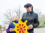 Mom Plays With Her Daughter On A Toy Ship Stock Photo