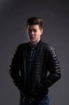 Casual Young Man In Black Leather Jacket And Denim Jeans Stock Photo