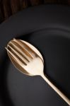 Black Empty Plate Fork Spoon On Wooden Table Background Stock Photo