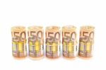 Rolls Of Euro Bills In Row On White Stock Photo