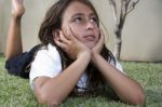 Girl Lying On Grass And Daydreaming Stock Photo