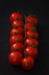 Organic Fresh Cherry Tomatoes On Black Board Background Stock Photo