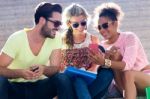 Group Of University Students Using Mobile Phone In The Street Stock Photo