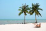 Chair And Table Set On The White Clean Sand Beach With Coconut Trees And Beautiful Sea Stock Photo