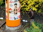 Advertising Column Being Updated With New Promotion Stock Photo