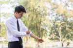 A Young Businessman Is Folding A White Sleeve On His Balcony Stock Photo