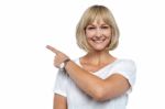 Smiling Woman Pointing Backwards Stock Photo