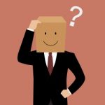 Confused Businessman With A Cardboard Box On His Head Stock Photo