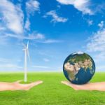 Hand Holding Wind Turbine And Earth Stock Photo