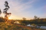 Spring Sun Rising Above Lake Stock Photo