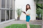 Portrait Of Thai Adult Businesswoman Beautiful Girl Using Her Tablet Stock Photo