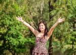 Young Beautiful Smiling Girl Holds Out Her Hands To The Sky Stock Photo