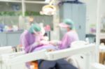 Dentist And Dental Assistants In Hospital ( Blurry Dental Background ) In Thailand Stock Photo