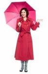 Woman Under Umbrella Trying To Feel Rain Stock Photo