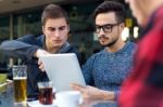 Outdoor Portrait Of Young Entrepreneurs Working At Coffee Bar Stock Photo