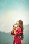 Beautiful Young Attractive  Asian Women In Red Dress On Sunrise Beautiful Nature Background Of The Mountains And Lotus Garden Image Of Happy  Camping, Travel, Lifestyle Resting , Relaxing Concept Vintage Style Stock Photo