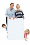 Lively Family Of Four All Around Blank Whiteboard Stock Photo