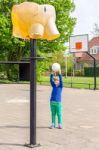 Young Girl Aiming Ball At Basket Like Elephant Stock Photo