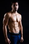 Beautiful And Muscular Man In Dark Background Stock Photo