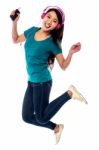 Music Lover Jumping High In The Air Stock Photo