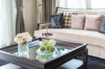 Glass Vase Of Flower On Wooden Table In Living Room Stock Photo