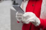 Woman In Red Coat With Smartphone In Hands Going Through The Cit Stock Photo